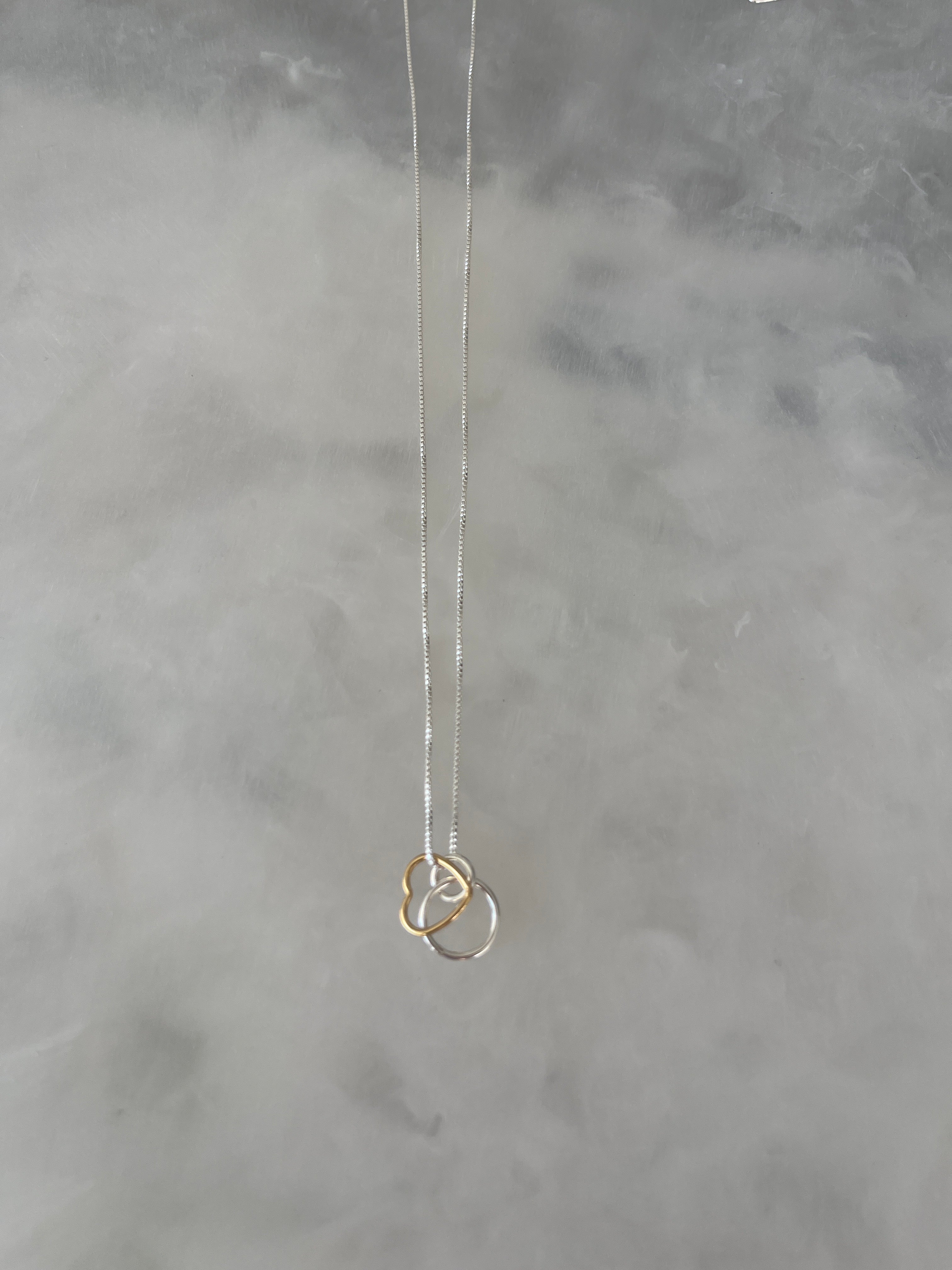 Solid silver necklace with silver circle link and gold heart