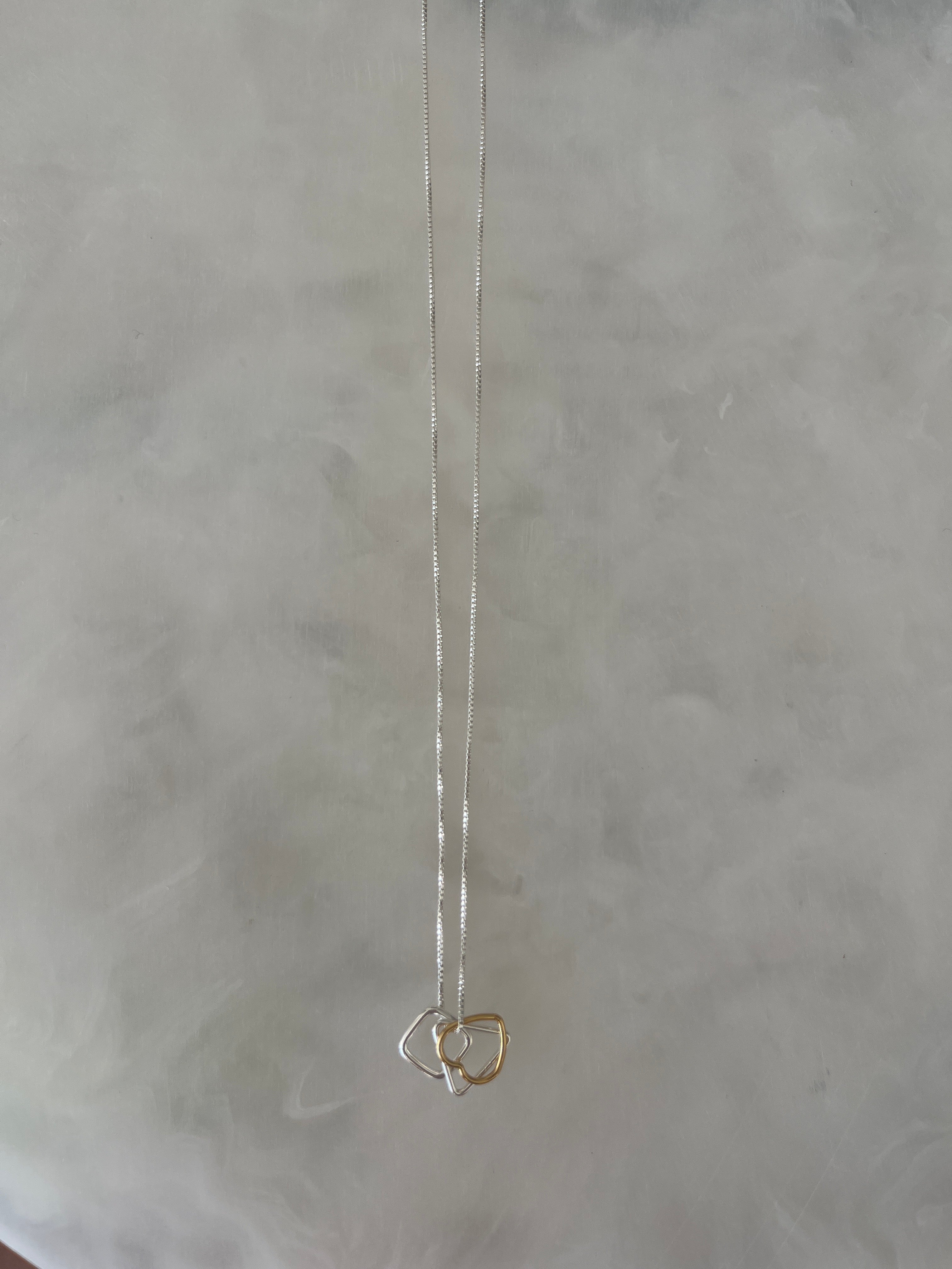 Silver Necklace With Silver & Gold Layered Pendants.