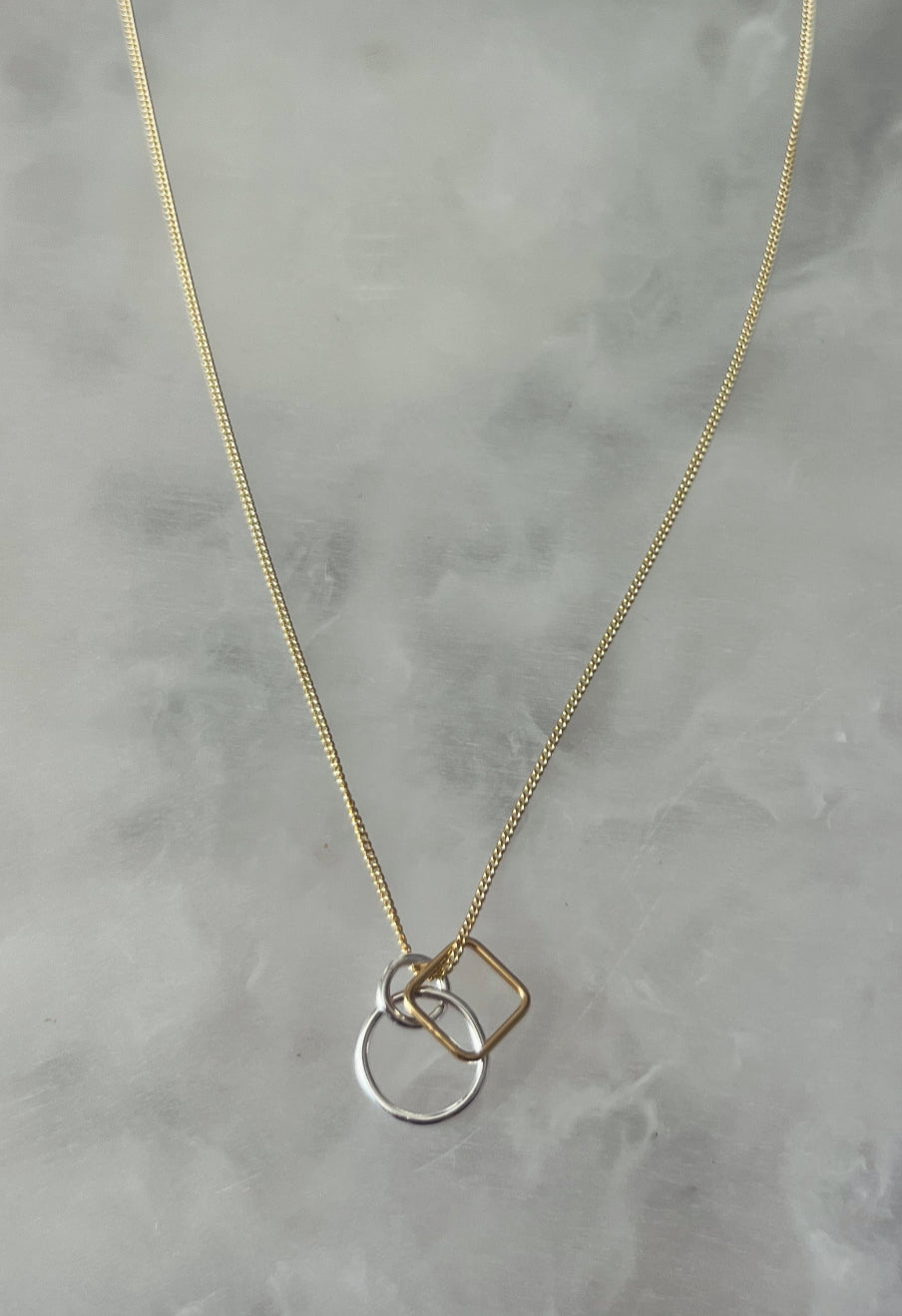 Gold chain with circles and square