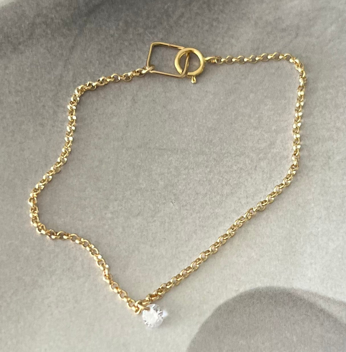 Gold bracelet with loose zircon