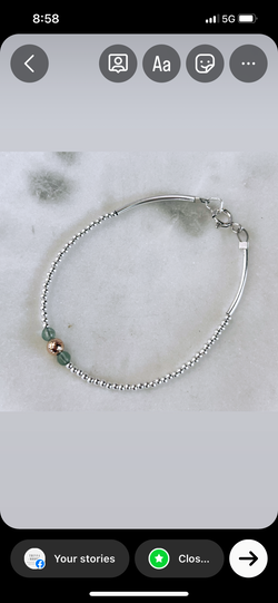 Solid silver bracelet with aqua gemstones and gold ball